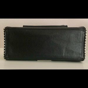 Steve Madden black handbag with adjustable crossbody/shoulder strap.